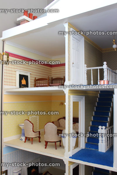 Stock image of inside of wooden toy dollshouse, rooms, staircase, furnishings