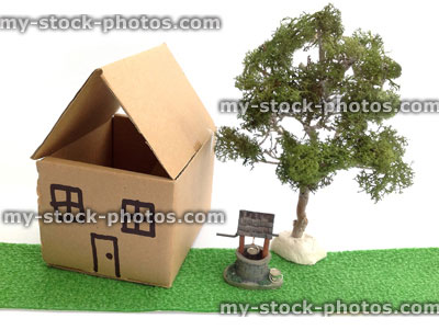 Stock image of cardboard dolls house, model wishing well and tree
