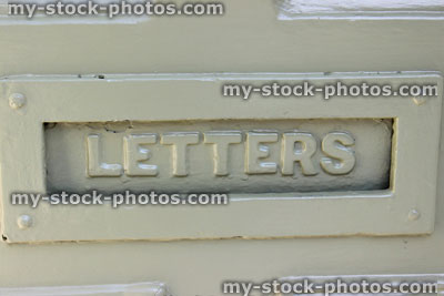 Stock image of letterbox on front door, painted pale green, 'LETTERS'