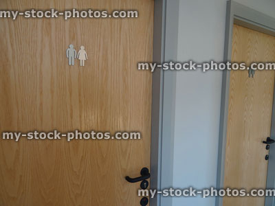 Stock image of unisex public toilets, men / women sign on door