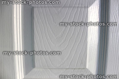 Stock image of wood panel on door, woodgrain painting with white paint