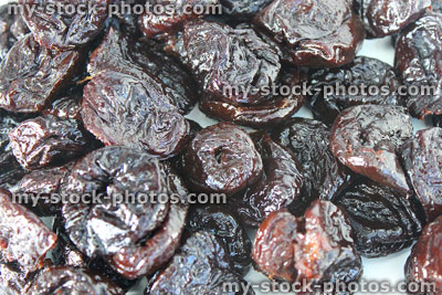 Stock image of pile of dried prunes / stoned fruit, healthy food