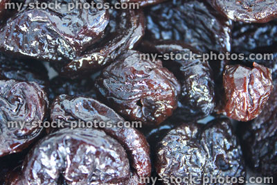 Stock image of pile of dried prunes / stoned fruit, healthy food, constipation problems