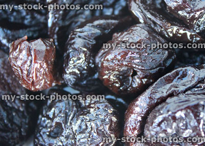 Stock image of pile of dried prunes / stoned fruit, healthy food