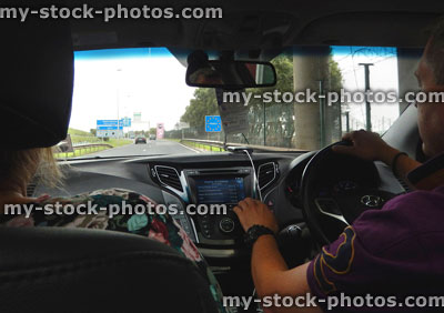 Stock image of couple driving in France, crossing French border, signpost, using sat nav