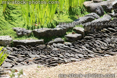 Stock image of Japanese garden dry stream, made with slate paddlestones / pebbles