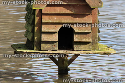 Stock image of entrance hole to duck house nestbox on plinth