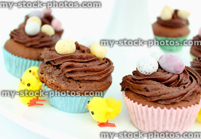 Stock image of tier on a cake stand displaying Easter cakes