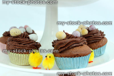 Stock image of tier on a cake stand displaying Easter cakes 