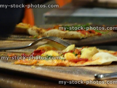 Stock image of pizza of wooden board / table, defocussed for background
