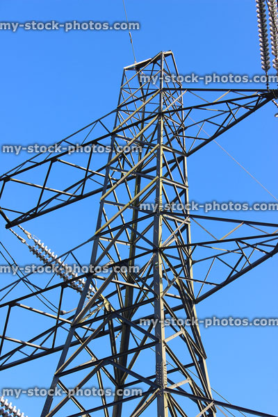 Stock image of electricity pylon / transmission tower, cage, wires, insulators, top peak