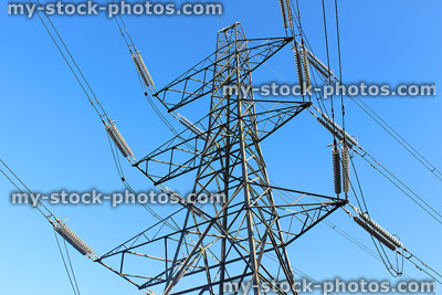 Stock image of electricity pylon / transmission tower, cage, wires, insulators, low angle