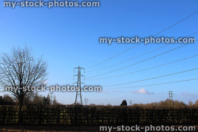 Stock image of electricity pylon / transmission tower, cage, wires, insulators, countryside view