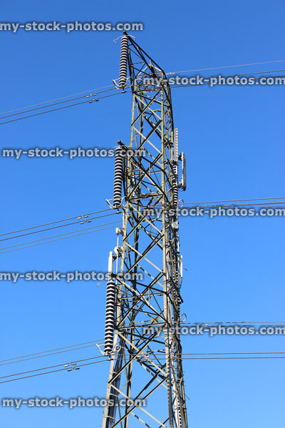 Stock image of electricity pylon / transmission tower, cage, wires, insulators, top / peak