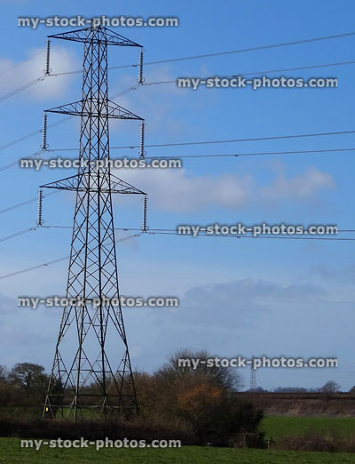 Stock image of electricity pylon / transmission tower, cage, wires, insulators, farmer's field / countryside