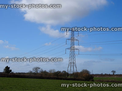 Stock image of electricity pylon / transmission tower, cage, wires, insulators, field, hedgerows