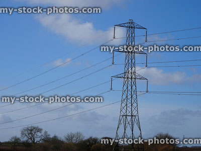 Stock image of electricity pylon / transmission tower, cage, wires, insulators, cloudy blue sky
