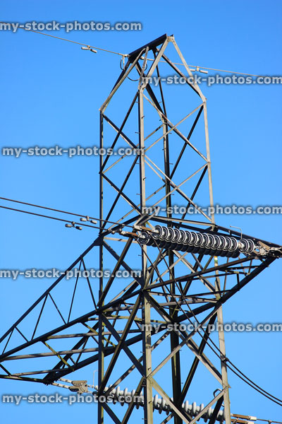 Stock image of electricity pylon / transmission tower, cage, wires, insulators, peak