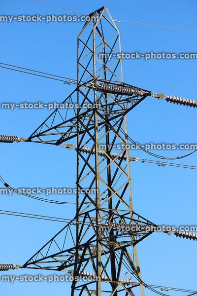 Stock image of electricity pylon / transmission tower, cage, wires, insulators, steel lattice peak