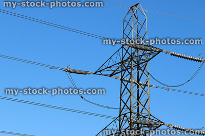 Stock image of electricity pylon / transmission tower, cage, wires, insulators, sky background