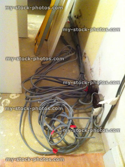Stock image of electrical wiring in kitchen, tangle of electric wires
