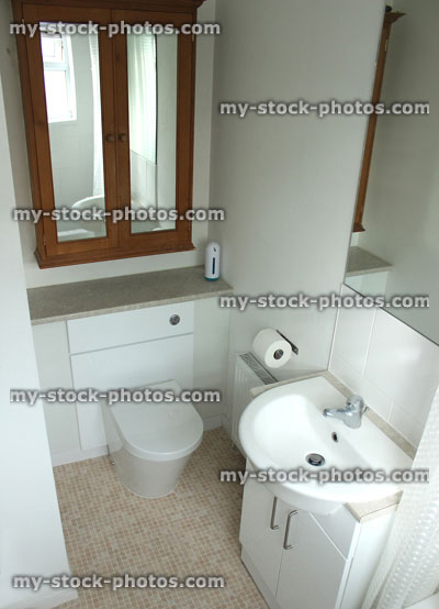 Stock image of modern en suite bathroom with white sink