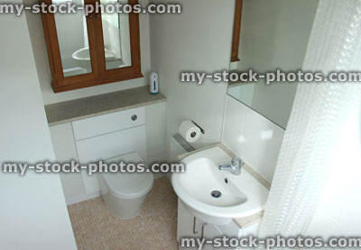 Stock image of modern en suite bathroom with white sink