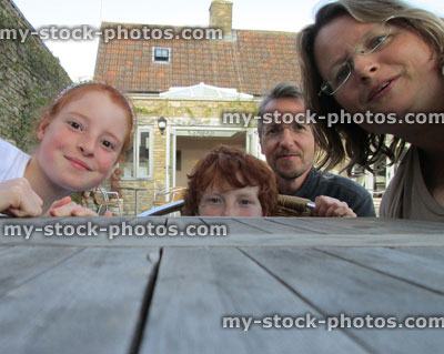 Stock image of young family having fun in sunny pub gardens 