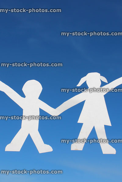 Stock image of boy and girl cutouts, people paperchains, white paper