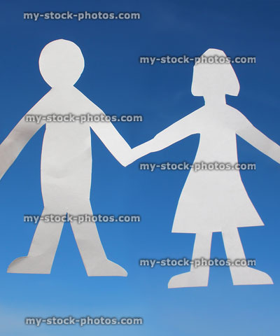 Stock image of husband and wife cutouts, people paperchains, white paper