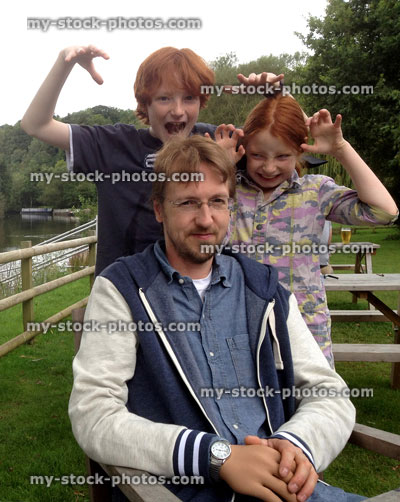 Stock image of young family in gardens, with children being silly