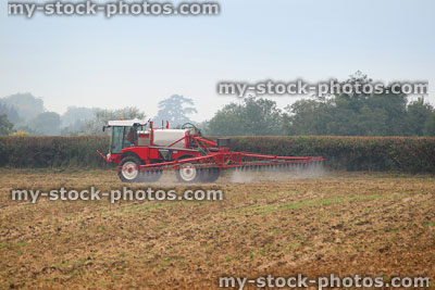 Stock image of farmer spraying crop / farm field with insecticide chemicals