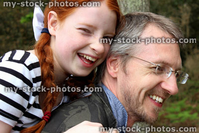 Stock image of happy father and daughter enjoying fun piggy back