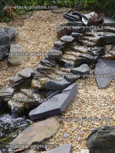 Stock image of interconnecting plastic / fibreglass pond waterfalls on gravel slope