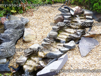 Stock image of artificial waterfalls with plastic slate rocks, flowing water