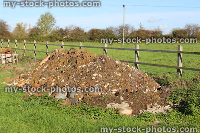 Stock image of field with pile of rubble soil mound / rubbish dump heap / fly tipping