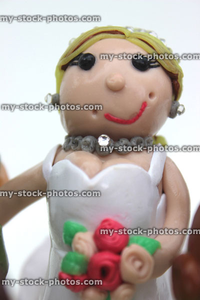 Stock image of homemade wedding cake topper (polymer clay), blonde bride, white wedding dress