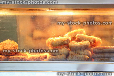 Stock image of battered sausages, fishcakes, fish and chip shop display
