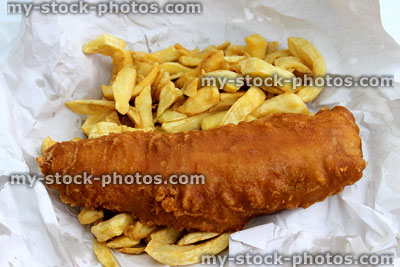Stock image of battered fish and chips in white paper