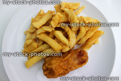 Stock image of battered sausage and chips on a white plate (close up)