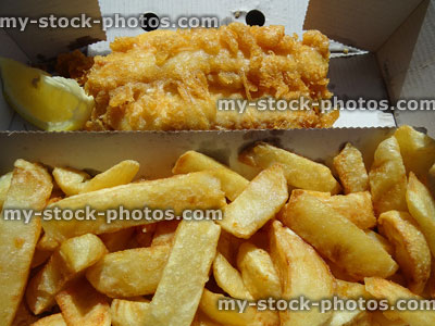 Stock image of crunchy fish and chips in takeaway cardboard box