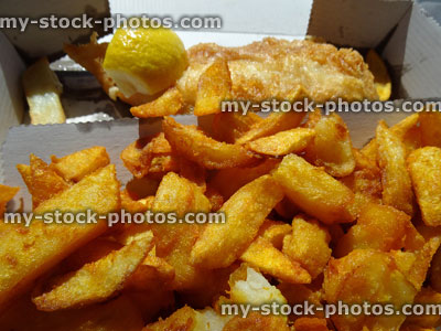 Stock image of fish / cod with battered chips / crispy potato wedges