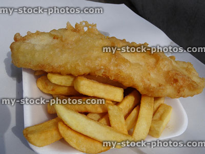 Stock image of freshly cooked battered cod / fish and chips in polystyrene tray