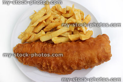Stock image of battered fish and chips on a white plate