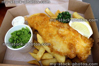 Stock image of fish and chips (cod) in box with peas, tartar sauce