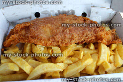 Stock image of greasy, takeaway fish and chips (cod) in box 