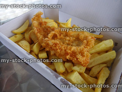 Stock image of takeaway white cardboard box with battered cod / fish and chips