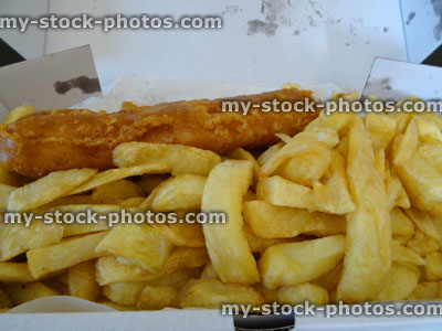 Stock image of greasy, takeaway fish and chips (cod) in box 