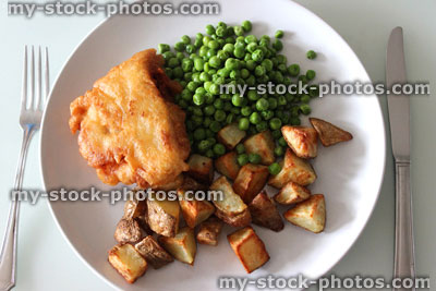 Stock image of homemade gourmet fish and chips (cod, potatoes, peas)