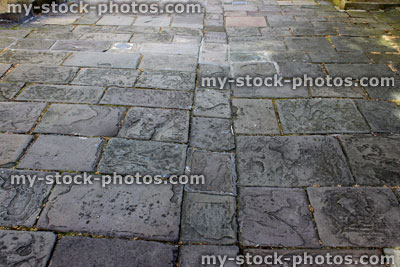 Stock image of historic flagstone paving, old grey flag stones